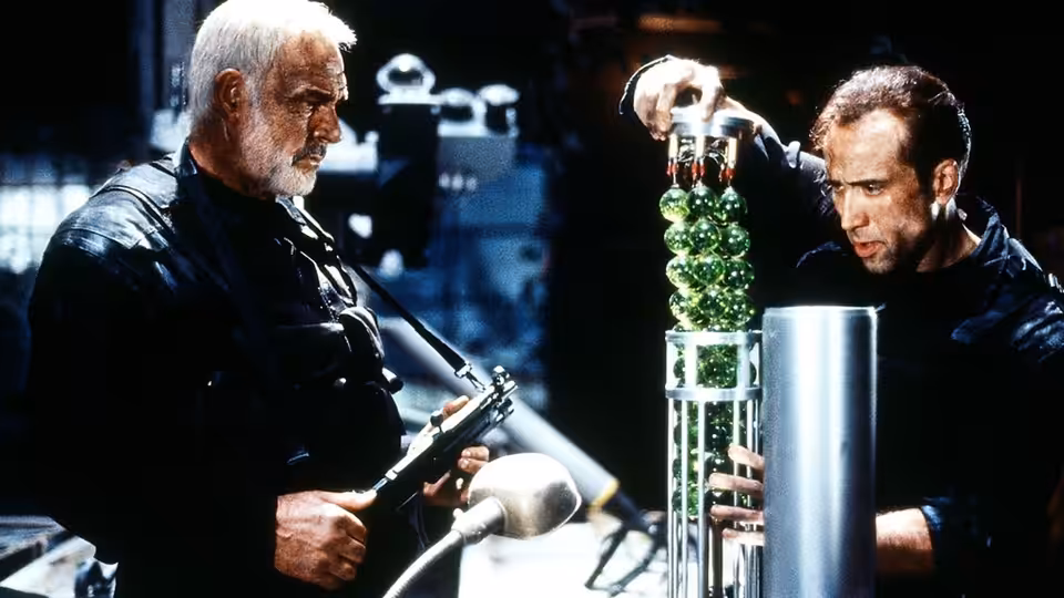 John Patrick Mason (Sean Connery) and Dr. Stanley Goodspeed (Nicolas Cage) handling green canisters