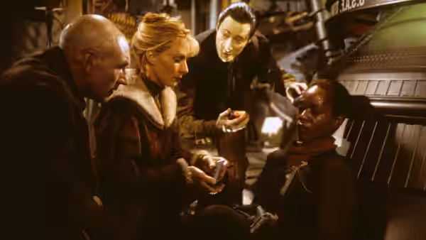 Picard (Patrick Stewart) and officers attend to a seated crew member