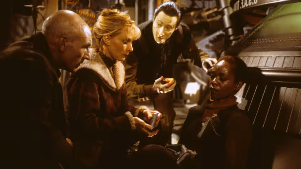 Picard (Patrick Stewart) and officers attend to a seated crew member