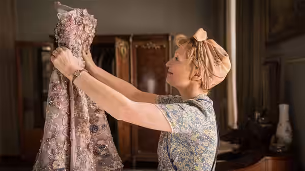 Ada Harris (Lesley Manville) admires an embroidered gown in a fashion house