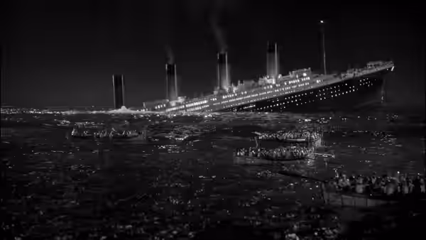 The Titanic sinks as lifeboats drift across the dark sea