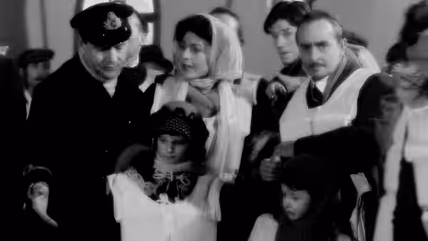 A uniformed officer and passengers gather with children during evacuation
