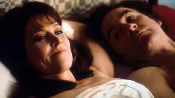 Janey Carver (Sigourney Weaver) and Ben Hood (Kevin Kline) lying together in bed