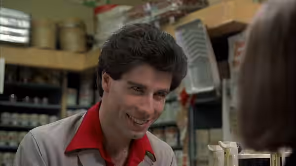 Tony Manero (John Travolta) smiling in a store