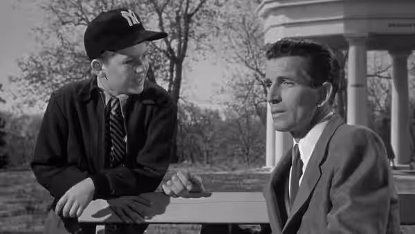 Bobby Benson (Billy Gray) talks with Klaatu (Michael Rennie) at a park bench