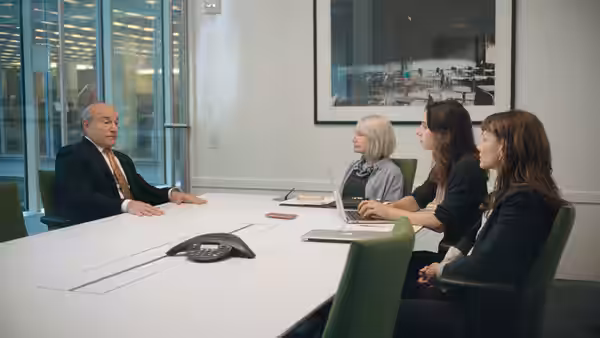 Dean Baquet (Andre Braugher) meets with three women across a conference room table