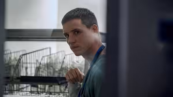 Charles Cullen (Eddie Redmayne) looks over his shoulder beside hospital supply baskets