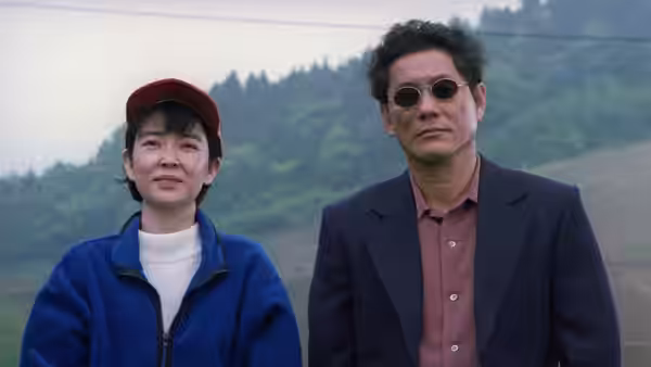 Yoshitaka Nishi (Takeshi Kitano) and his wife standing outdoors