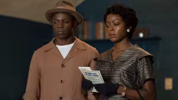 Mamie Till-Mobley (Danielle Deadwyler) and Gene Mobley (Sean Patrick Thomas) read a pamphlet indoors