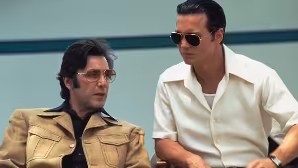 Lefty (Al Pacino) and Donnie Brasco (Johnny Depp) seated indoors in conversation
