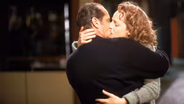 Melvin Udall (Jack Nicholson) and Carol Connelly (Helen Hunt) embracing each other