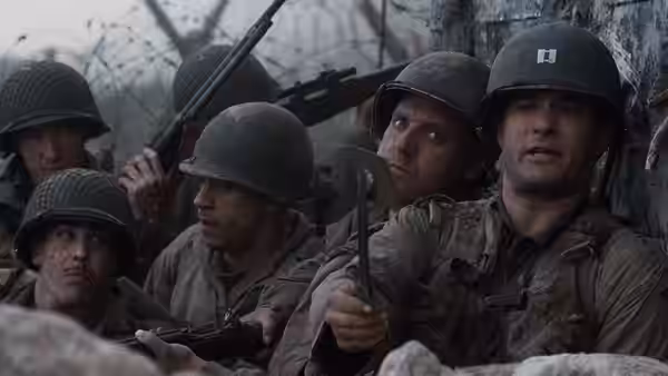 soldiers in helmets taking cover behind rocks with weapons ready