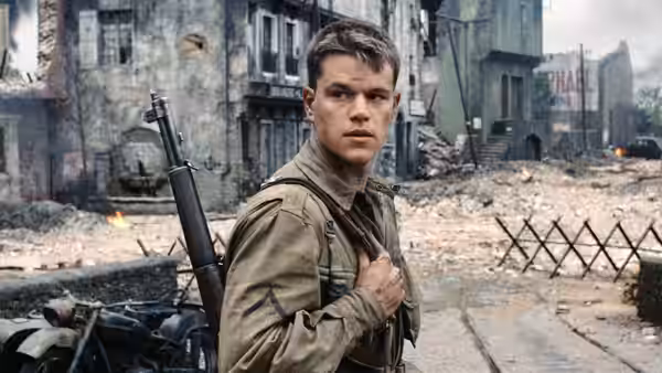 a soldier holding his rifle strap in a ruined town