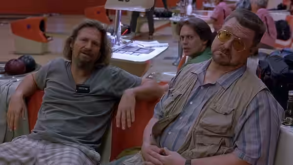 The Dude (Jeff Bridges) and Walter Sobchak (John Goodman) in a bowling alley lounge