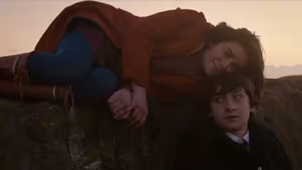 Jordana Bevan (Yasmin Paige) lies on rocks beside Oliver Tate (Craig Roberts) at dusk
