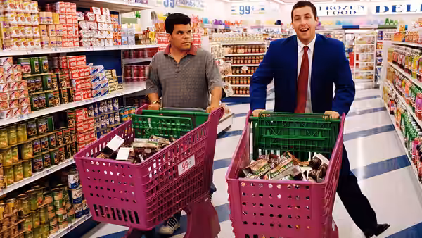 Barry Egan (Adam Sandler) and a man pushing shopping carts in a supermarket