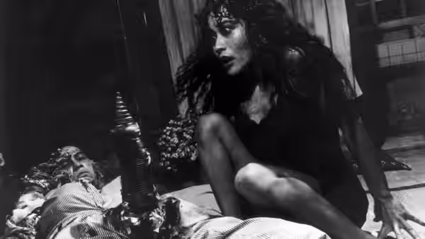Girlfriend (Kei Fujiwara) kneeling over the prone Salaryman on the floor