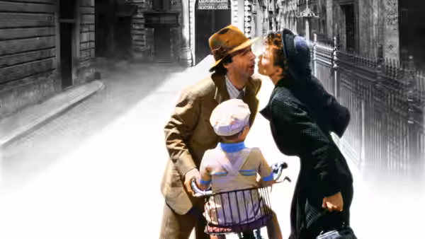 Guido (Roberto Benigni) riding a bicycle with Dora (Nicoletta Braschi) and Giosué (Giorgio Cantarini)