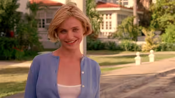 Mary (Cameron Diaz) smiling while standing on a suburban sidewalk