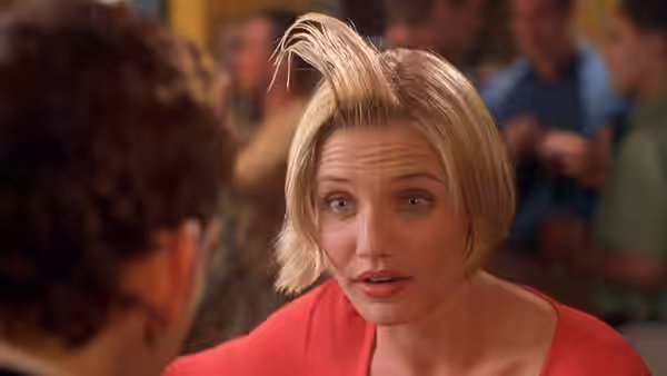 Mary (Cameron Diaz) speaking to a man while seated indoors
