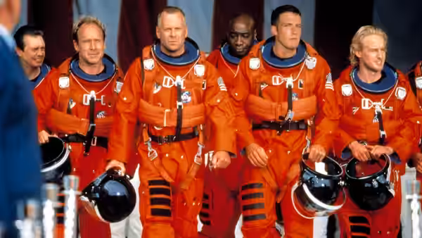 Harry Stamper (Bruce Willis) and A.J. Frost (Ben Affleck) among astronauts holding helmets