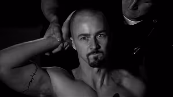Derek (Edward Norton) having his head shaved by two men
