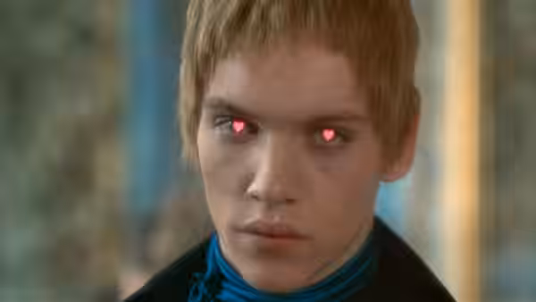 Close-up of young man with short hair and glowing red eyes