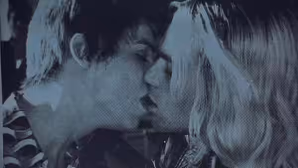 Two people press their faces together about to kiss