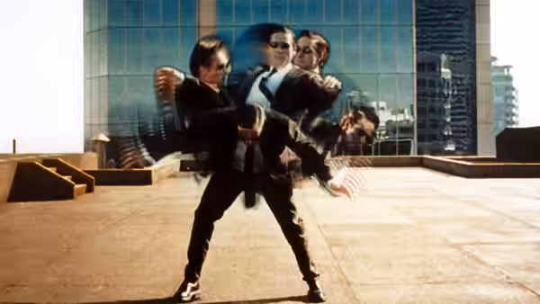 Agent Smith (Hugo Weaving) dodging bullets on a city rooftop