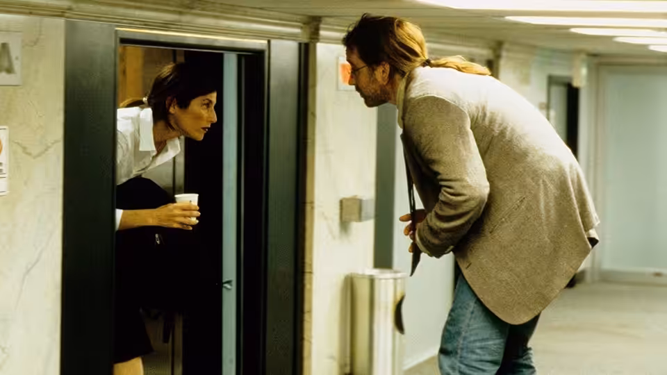 Maxine (Catherine Keener) speaking with Craig (John Cusack) outside an elevator