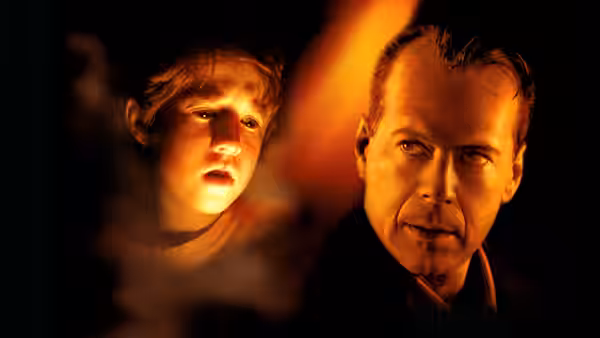 Cole Sear (Haley Joel Osment) and Malcolm Crowe (Bruce Willis) in dramatic lighting