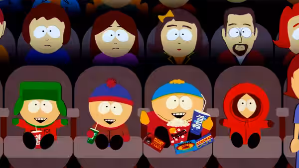 Four children in theater seats holding popcorn and candy boxes