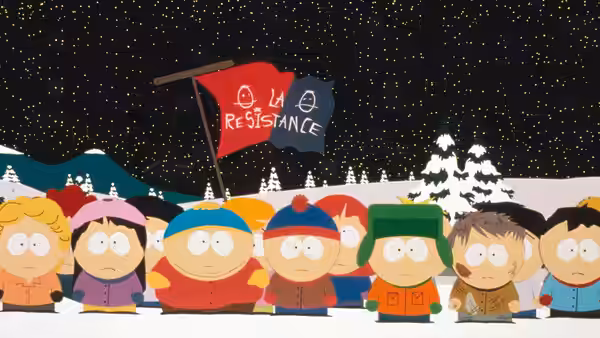 Group of children standing in snow holding a resistance flag at night