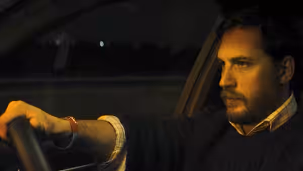Ivan Locke (Tom Hardy) driving at night with a focused gaze