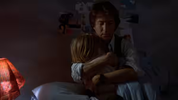 Ted Kramer (Dustin Hoffman) hugging Billy Kramer (Justin Henry) in a dimly lit bedroom