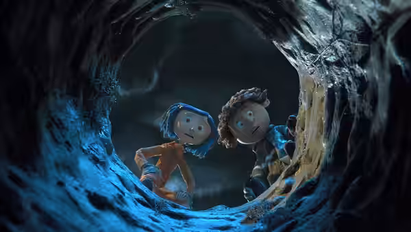 Coraline Jones (Dakota Fanning) and Wybie Lovat (Robert Bailey Jr.) in a rocky tunnel