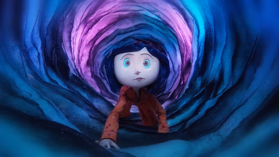 Coraline Jones (Dakota Fanning) crawling inside a swirling blue and pink tunnel