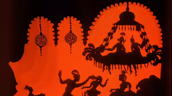 Silhouetted figures gather beneath a palace chandelier as others dance below