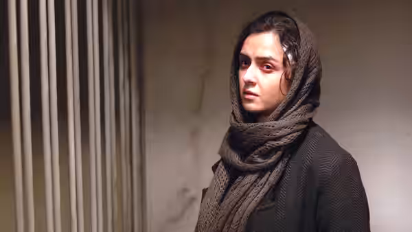 A young woman in brown headscarf stands in a marble hallway