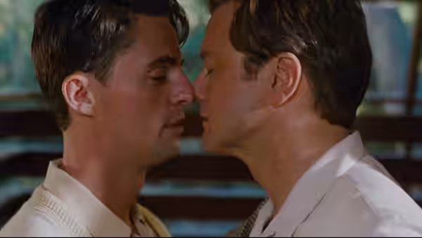 George (Colin Firth) and Kenny (Nicholas Hoult) lean in to kiss