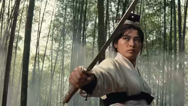 Yang Hui-zhen (Hsu Feng) raises a sword among the trees