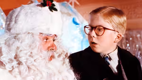 Ralphie (Peter Billingsley) looks at Santa during a department store visit