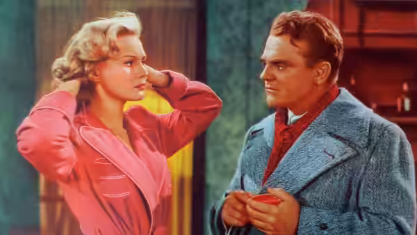 Verna Jarrett (Virginia Mayo) stands beside a man holding a small object