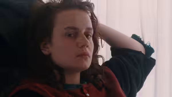 Mona (Sandrine Bonnaire) reclines indoors with one arm behind her head