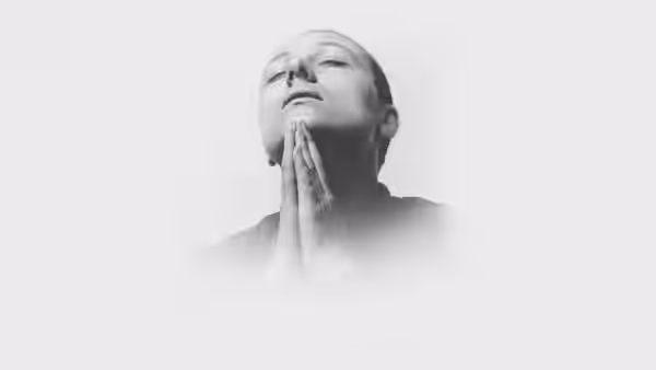 Jeanne d'Arc (Maria Falconetti) clasping hands in prayer with eyes closed