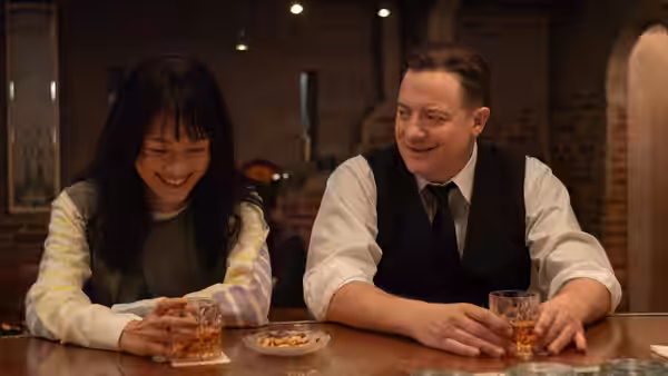 Phillip Vanderploeg (Brendan Fraser) at a bar with a smiling woman