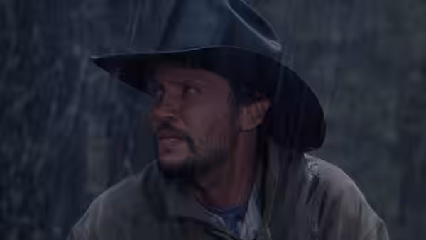 Phil Berquist standing in pouring rain wearing a black cowboy hat
