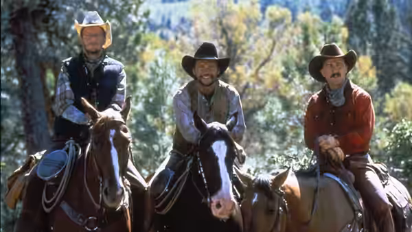 Mitch Robbins, Phil Berquist and Ed Furillo riding horses through wooded countryside