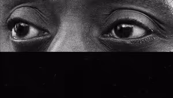 Close-up of intense eyes looking sideways in black and white