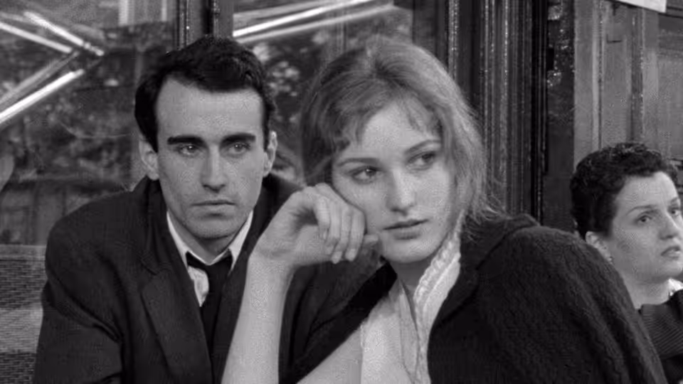 Michel (Martin LaSalle) sits beside Jeanne (Marika Green) as she rests her chin on her hand